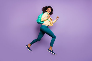 Fototapeta na wymiar Profile side photo of casual positive charming pretty sweet girl in aspiration for discount running jumping overjoyed ecstatic girl in pants trousers footwear isolated pastel color violet background
