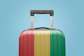 Baggage with Guinea flag print tourism and vacation concept.