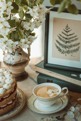 Vintage cup with tea and flowers
