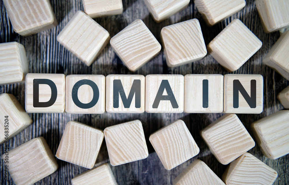 Aufkleber domain name - text concept website on a wooden background surrounded by cubes