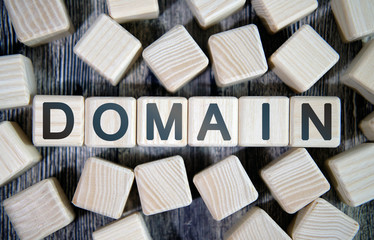 Domain name - text concept website on a wooden background surrounded by cubes