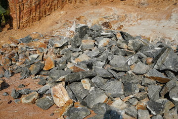 Pile Of Rocks I.E. Lithium Mining And Natural Resources Like Limestone Mining In Quarry. Natural Zeolite Rocks Are Excavated With Deforestation In Background.