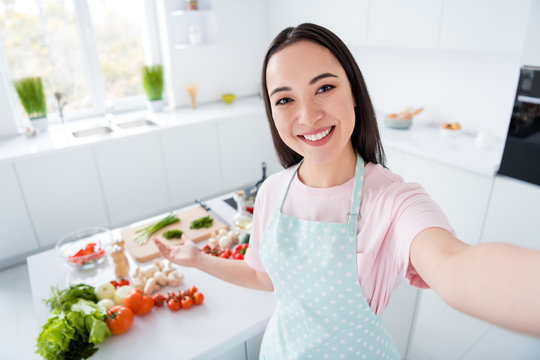 Self-portrait Of Her She Nice Attractive Cheerful Cheery Girl Cooking Teaching Domestic Luncheon Meal Veg Recording Video Live Streaming Workshop In Modern Light White Interior Kitchen