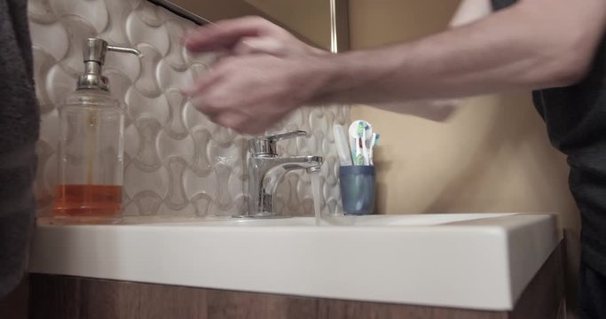 Washing hands thoroughly in the white sink