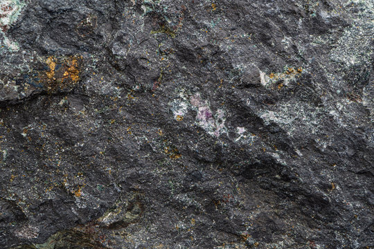 Magnetite iron ore texture close-up. Contains magnetit, pyrite, calcite, magnesioferrite, spinel, fluorite. Siberian natural resources deposit. Mineral stone surface background.