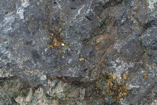 Magnetite iron ore texture close-up. Contains magnetit, pyrite, calcite, magnesioferrite, spinel, fluorite. Siberian natural resources deposit. Mineral stone surface background.
