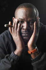 Portrait of a black man with a cigar.
