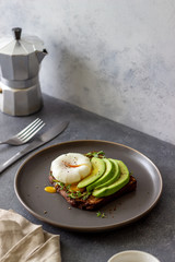 Sandwich with avocado and poached egg. Healthy eating Vegetarian food. Breakfast.