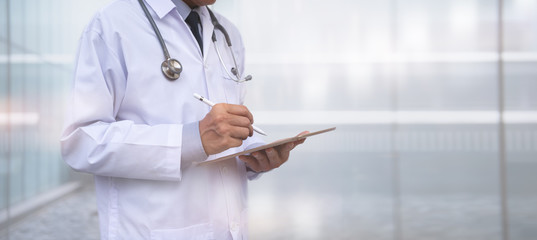 Doctor using digital tablet in hospital