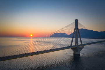 Fototapeta premium Bridge near Patras city in Greece. Breathtaking sunset scenery with epic red sky.