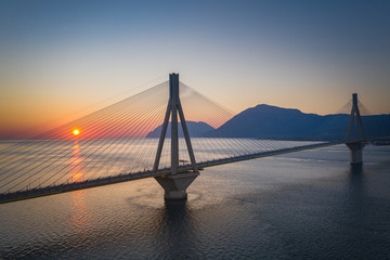 Bridge near Patras city in Greece. Breathtaking sunset scenery with epic red sky.