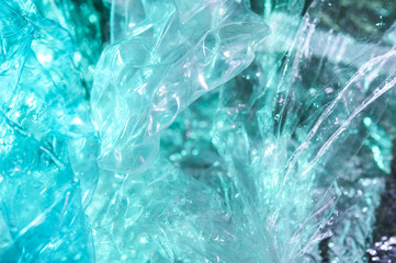 Holographic background in the style of the 80-90s. Real texture of cellophane film in bright acid colors.