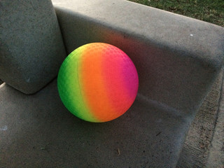 Modern art rainbow sphere geometric shapes in space on gray concrete