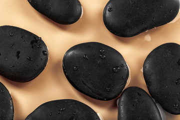 Massage spa stones close up in wavy water background