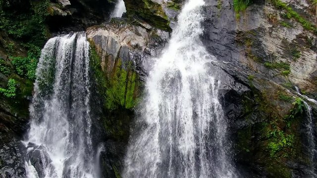 Video of slow motion and backward movement by drone at Krung Ching Waterfall in raining season. There is placed in Abundant forest at Nakhon Si Thammarat province. 