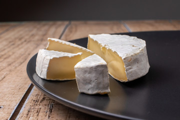 Camembert cheese - soft fatty cheese with a crust of white mold. Cow's milk cheese.