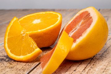 Fototapeta na wymiar Orange and grapefruit on a wooden background. Tropical Citrus Fruits, Vitamin C.