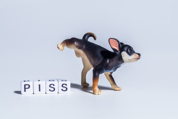 miniature figure concept of pissing dog