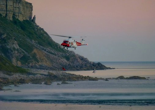 Low Angle View Of Helicopter Flying Over Beach