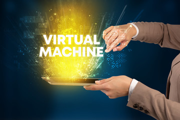Close-up of a touchscreen with VIRTUAL MACHINE inscription, innovative technology concept