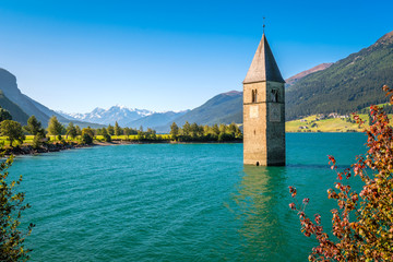 Lake Resia (Reschensee) and Ortler Mountains in Val Venosta (Alto Adige, Italy). It is famous for the tower of a 14th-century church of village Graun that submerged when the lake was deepened in 1950