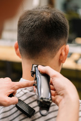 Close-up view of male hairdresser giving a haircut