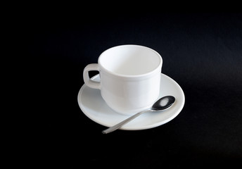 set: white mug and saucer on a black background. Suitable for mockups