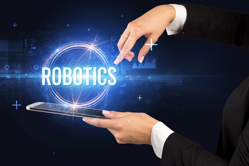 Close-up of a touchscreen with ROBOTICS inscription, new technology concept