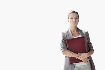 Obraz premium Young attractive businesswoman standing while holding document