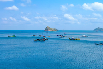Fototapeta premium The beautiful tropical beach of Nam Du, the paradise island with the coast, white sand, clean water, boat, forest and blue sky. Nam Du island is a popular tourist destination in Kien Giang, Vietnam