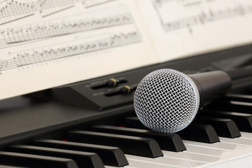 microphone on the electric piano and music paper