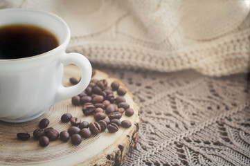 White cup of black hot coffee drink and coffee beans