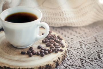 White cup of black hot coffee drink and coffee beans