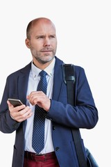Portrait of businessman using smartphone while waiting for the train in station