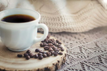 White cup of black hot coffee drink and coffee beans