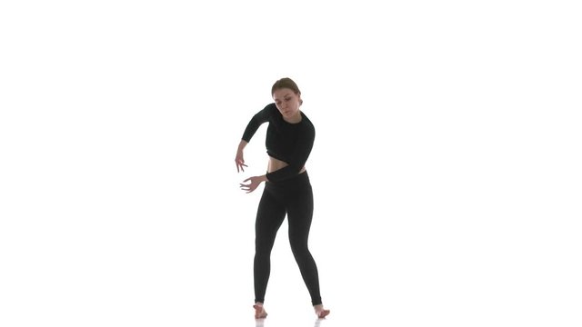 young beautiful woman dancer in black short top and black leggings emotionally dancing contemporary, modern ballet dance, isolated, slow motion