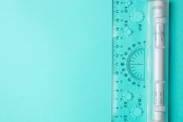 Architect ruler on a blue background with copyspace. Top view.