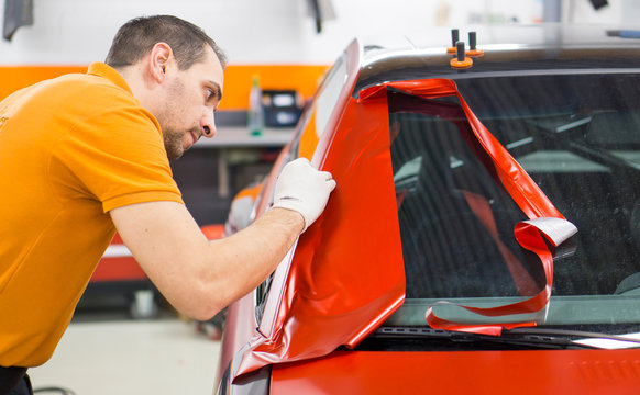 Car wrapping with red adhesive film