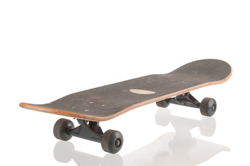 Old used skateboard isolated on white background © unclepodger