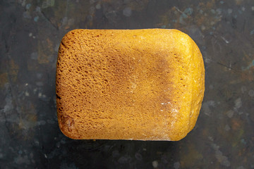 Fresh fragrant bread against a dark background. Assortment of baked bread on dark table background....