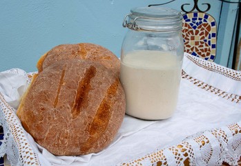 Sourdough  Bread and  starter dough  fresh baked  bread  in cottage setting 