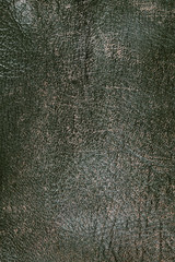 Old brown leather, background and texture. Vertical color photo. 