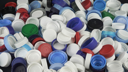 Plastic bottle caps for recycling. Recycling, solidarity and no plastic concept. Recycling of plastic caps and take care of the environment. 