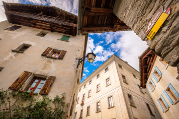 Walking sings near the village of Soglio (Val Bregaglia, Graubünden, Switzerland). The yellow points towards villages Stampa and Caccior, the brown indicates that the hiking path is the Via Bregaglia