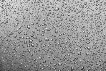 Close-up water  drops on surface of grey backdrop or background, water texture, top view, high...