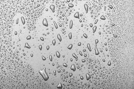 Close-up water  drops on surface of grey backdrop or background, water texture, top view, high resolution