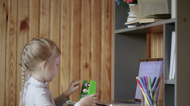 Girl using abacus during remote learning