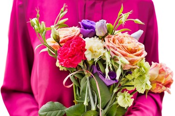 Portrait of young attractive woman holding boquet of flowers