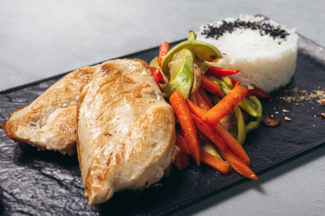 grilled chicken breast and grilled vegetables served on plate