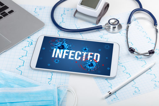 Tablet pc and doctor tools on white surface with INFECTED inscription, pandemic concept